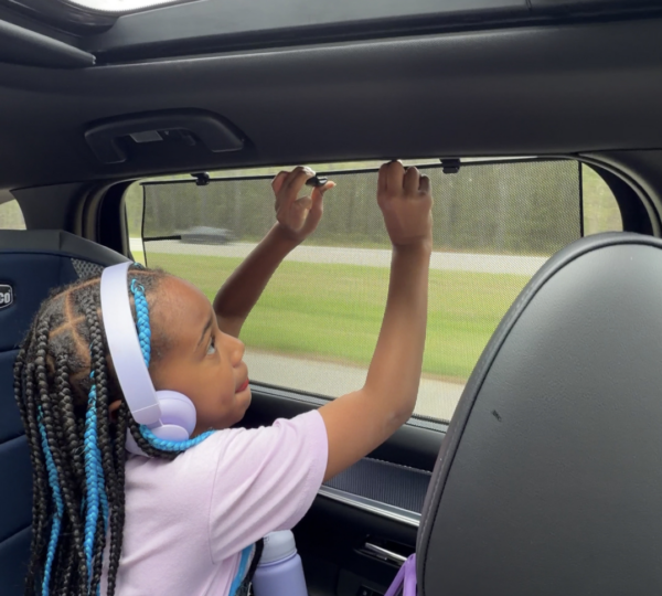 Child using the rear sun shade of the 2026 Mazda CX-90