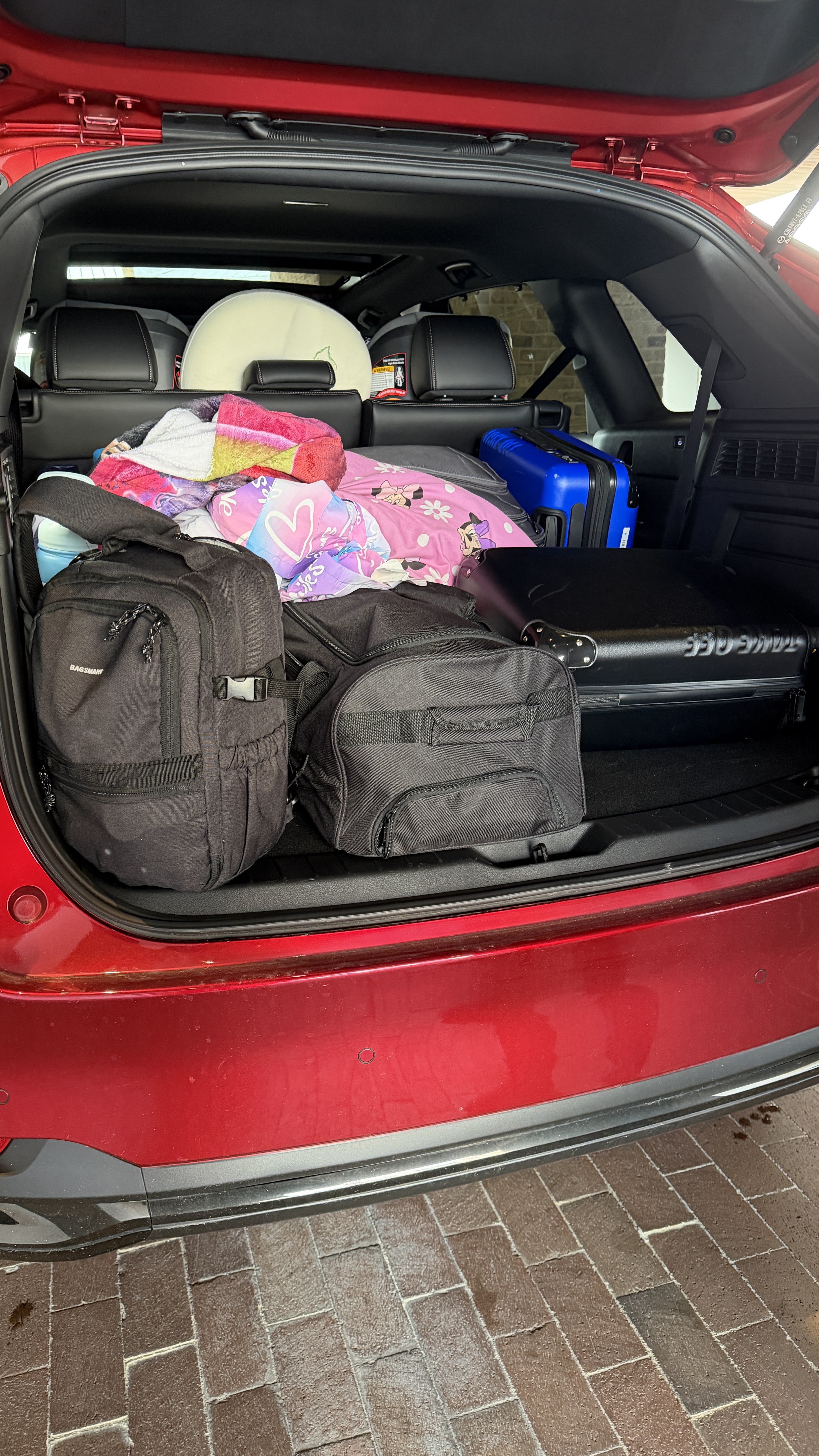 The trunk of the 2026 Mazda CX-90 filled with luggage for a road trip