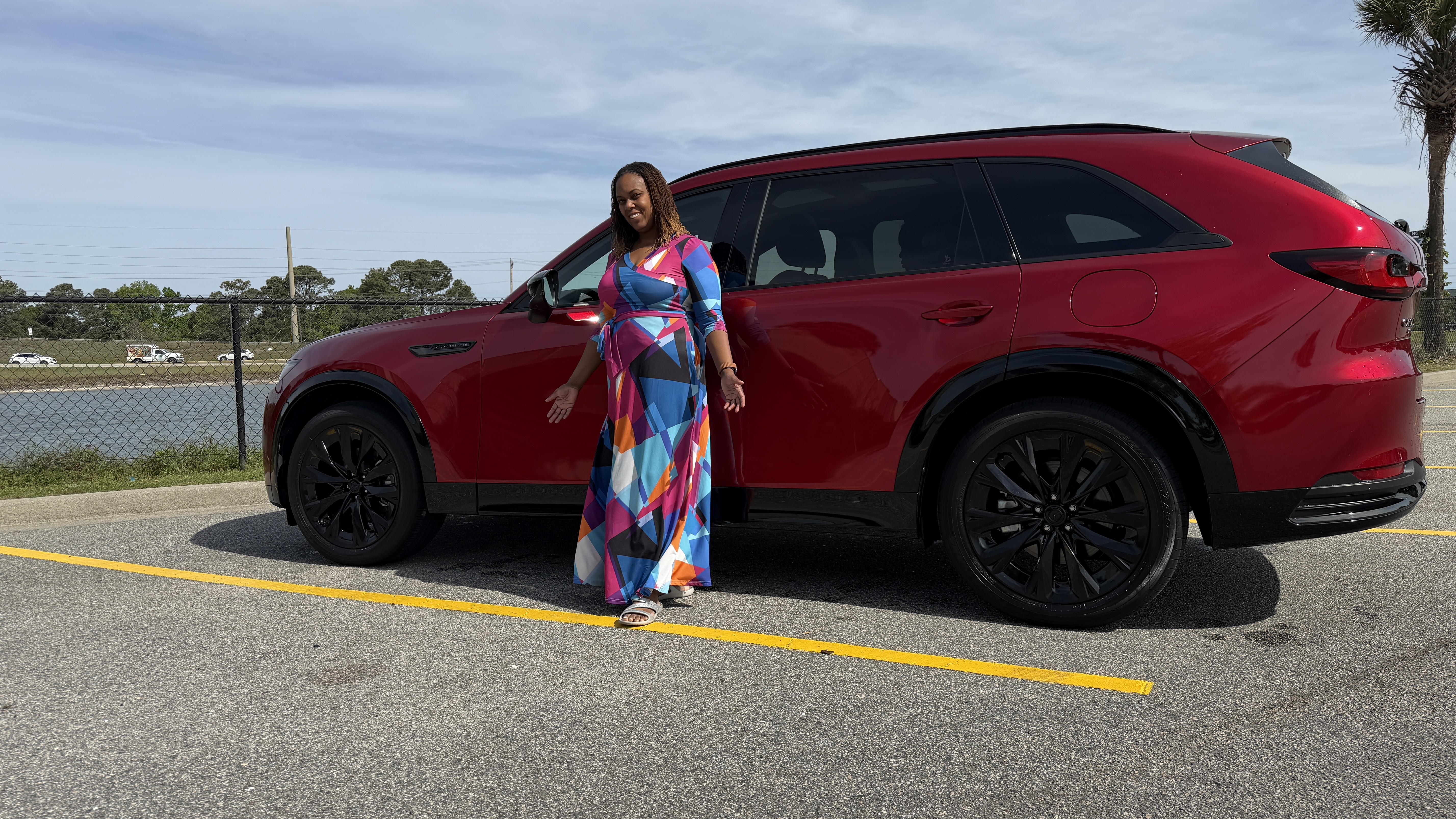 Lisa Summers smiling in front of the 2026 Mazda CX-90